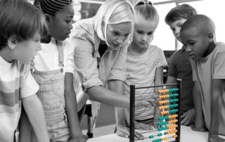 blond lady showing stupid children how to use an outdated abacus