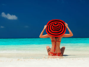 girl on beach with red hat